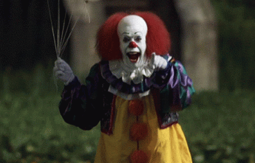 Clown With Red Hair Holding Balloon GIF