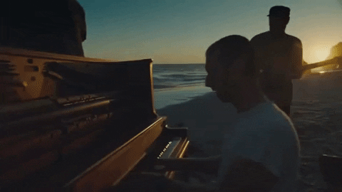 Coldplay Performing On Beach At Sunset GIF
