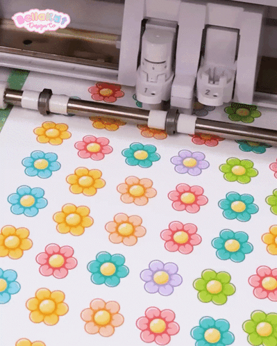 Colorful Flowers Cut Out Of Paper By Machine GIF