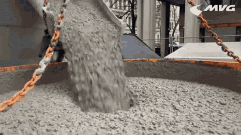 Concrete Is Being Poured Into A Large Container With The Word Mvg In The Corner GIF