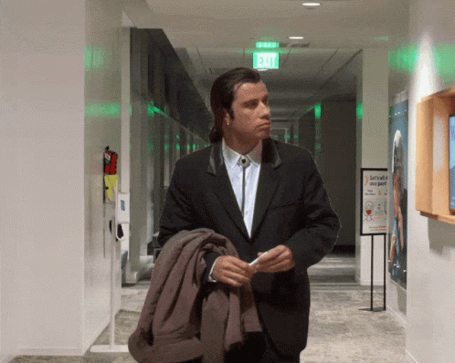 Confused Actor John Travolta In The Hallway GIF