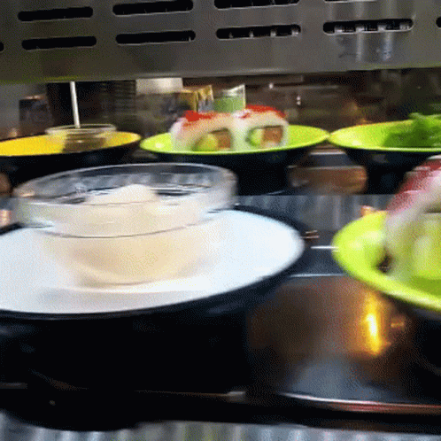 Conveyor Belt With Plates Of Food And Bowl Of Soup GIF