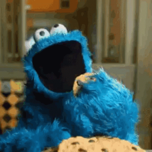 Cookie Monster Eating A Cookie With His Mouth Open GIF