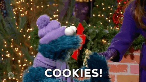 Cookie Monster From Sesame Street Is Giving A Gift To A Woman GIF