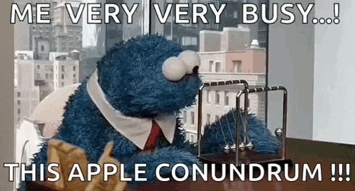 Cookie Monster From Sesame Street Is Sitting At A Desk With A Newton 'S Cradle In Front Of Him . GIF