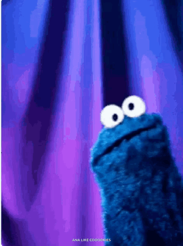 Cookie Monster From Sesame Street Looking Up At The Camera GIF