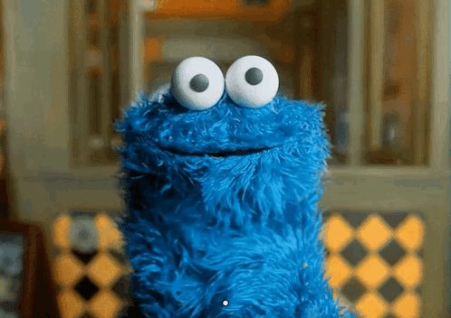 Cookie Monster From Sesame Street With Big White Eyes And A Smile On His Face GIF