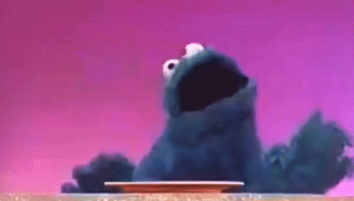 Cookie Monster Sitting on Table Mouth Open
