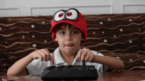 Cool Kid Using Vintage Joystick Controller GIF