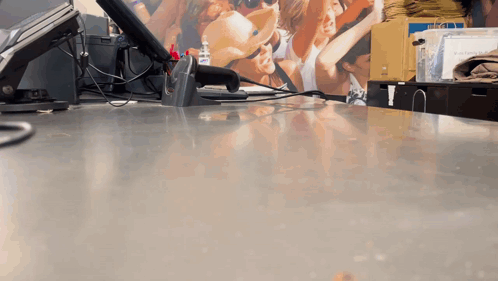 Counter With Scanner And People Picture On Wall GIF