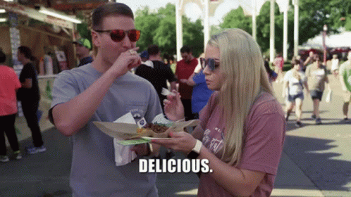Couple Eating at Festival Woman Says Delicious
