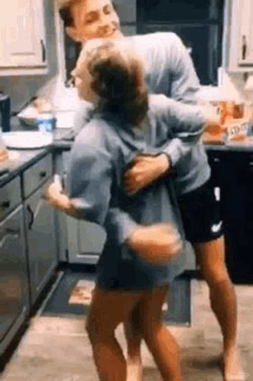 Couple Flirting In The Kitchen GIF