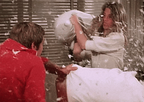 Couple Having Fun Pillow Fight GIF