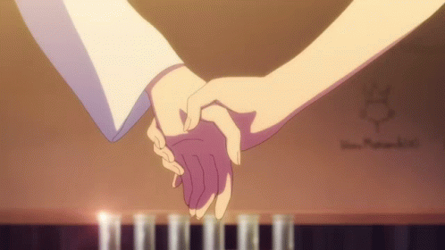 Couple Holding Hands in Front of Piano With Candles