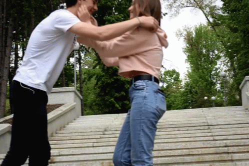 Couple Hug Kissing On Stairs GIF