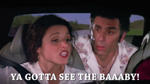 Couple in Car Saying Ya Gotta See the Baaaby