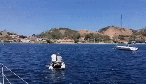 Couple In Small Boat In Ocean GIF