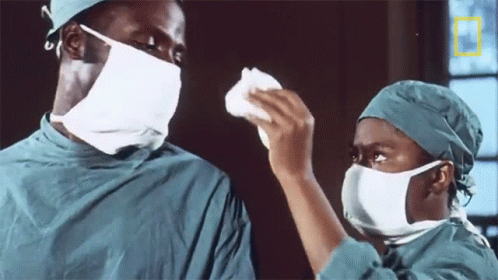 Couple in Surgical Masks with National Geographic Logo