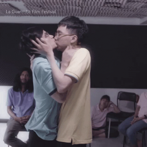 Couple Kissing in Front of La Guarimba Film Festival Poster