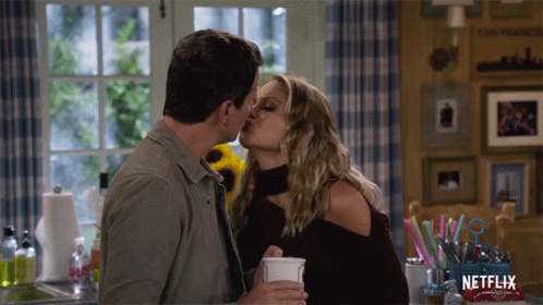 Couple Kissing in Front of Netflix Box