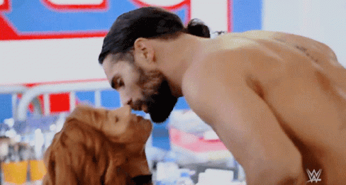 Couple Kissing in Front of W Sign