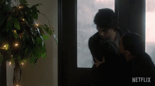 Couple Kissing in Front of Window With Netflix