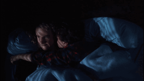 Couple Lying in Bed Saying Get Off Me in Red