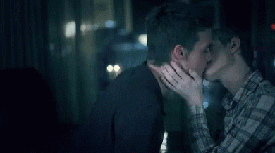 Couple Of Men Kissing In Front Of Window GIF