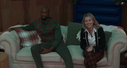 Couple Sitting On Couch With Plaid Pillows GIF