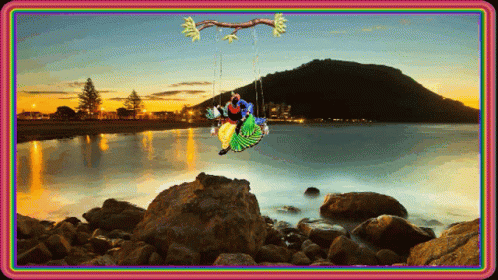 Couple Sitting on Swing Over Water