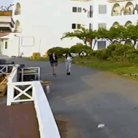 Couple Walking on Road near Building