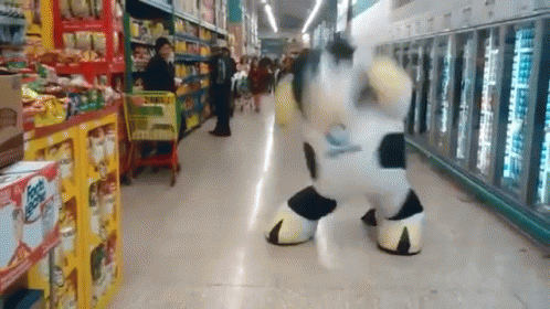 Cow Mascot Dancing In Grocery Store GIF