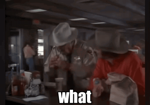 Cowboy Hat Man Calling Suit Man A Mental Case GIF