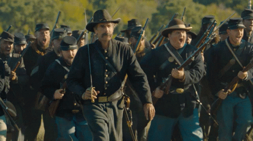 Cowboy Hat Man Leading Soldiers With Guns