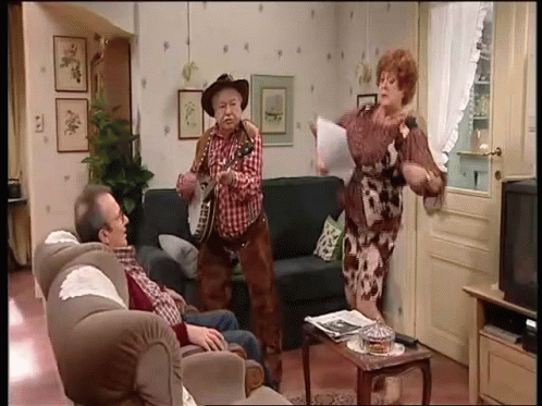 Cowboy Hat Man Playing Guitar With Two People