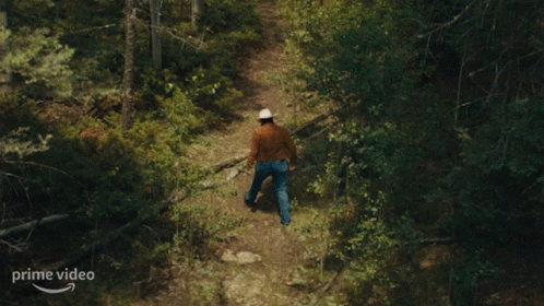 Cowboy Hat Man Walking On Prime Video Path GIF