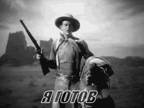 Cowboy Holding Gun on Horse in Desert