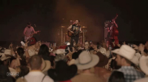 Cowboys Watching Band on Stage