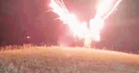 Crazy Jurassic Costume Holding Firecracker GIF