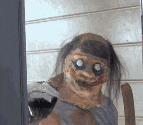 Creepy Clown Behind Glass Door Looking At Camera GIF
