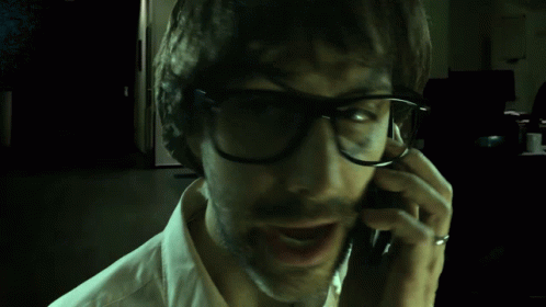 Creepy Guy Talking To His Phone GIF