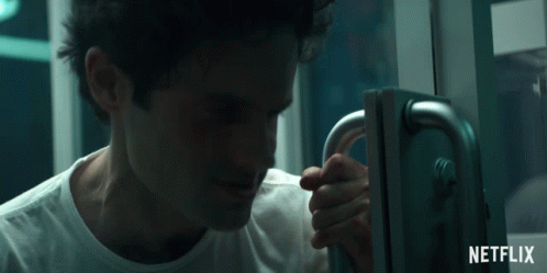 Creepy Laughing Joe Goldberg Holding Door GIF