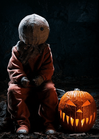 Creepy Sitting Creature With Pumpkin Lantern GIF