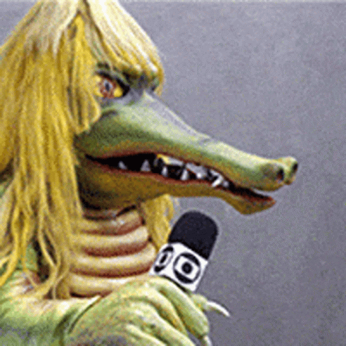 Crocodile With Long Hair Holding Microphone Saying 90