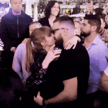 Crowd Around Kissing Man and Woman