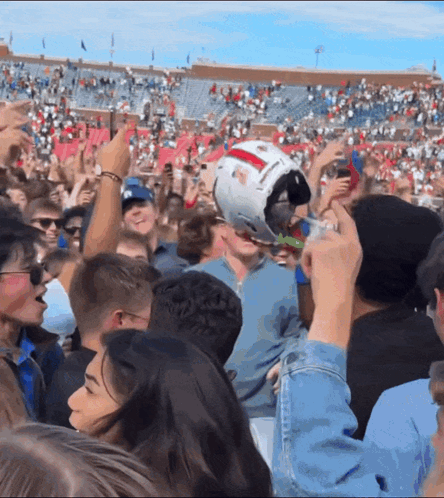 Crowd at Football Game With USC Helmet