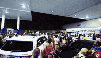 Crowd at Gas Station with White Mercedes