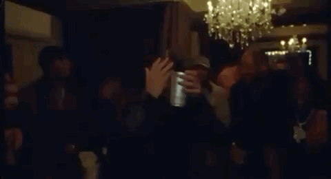 Crowd Dancing in Dark Room with Chandelier