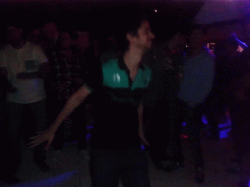 Crowd Dancing in Dark Room with Green Lights