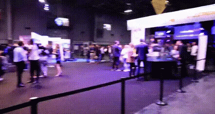 Crowd Gathered in Room With Purple Light